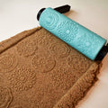 Photo of turquoise 3D printed repeating floral petal mandala pattern roller next to its clear imprint in brown clay showing petal arrangement detail