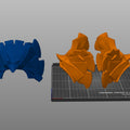 Slicer screenshot of the patriot hero's Eagle Shoulder armor STL, orange and blue 3D print parts on Prusa bed.