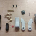 Disassembled parts of hero shooter game winged medic Blaster, 3D printed weapon cosplay prop breakdown
