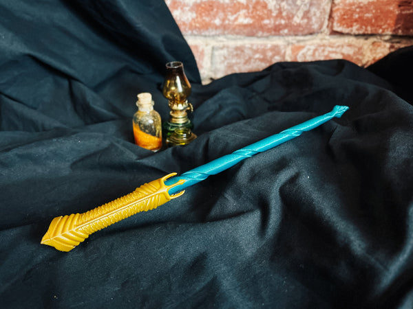 Collection of 3D printed magic wands featuring an Aquaman inspired cosplay prop with gold scales and teal shaft.