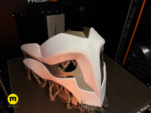 Lifestyle photo close-up of 3D printed Ekko Firelighter Mask Arcane against blue wall showing FDM layer lines and metallic bronze filament sheen