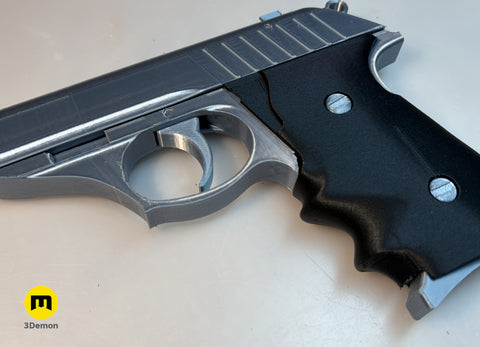 Lifestyle photo of 3D printed Grace Ashcroft Handgun RE Requiem low angle side profile black slide brown wood-grip on dark textured surface