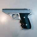 Lifestyle photo of painted 3D printed Grace Ashcroft Resident Evil Requiem handgun held in hand semi-matte black finish wood-texture grip high angle