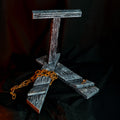 Lifestyle photo of 3D printed Shield Saw display stand alone painted dark grey weathered wood texture with rusty chain