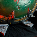 Close-up lifestyle photo of Shield Saw Doom weapon resting on base beams of 3D printed stand showing metallic vs wood texture