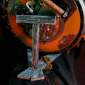 Lifestyle photo side profile view of 3D printed Doom Shield Saw prop on display stand showing depth and mechanical center