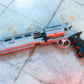 Decorative revolver gun with red light, silver and black accents on a concrete surface. Resident Evil Leon's prop 3D printed file by 3Demon.