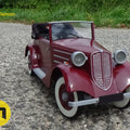 Lifestyle photo of RC model Tatra 75, maroon 3D printed scale car on gravel path