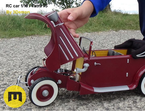 Hand photo of RC model Tatra 75, 1/10 scale, red 3D printed car with open hood.