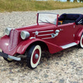 Lifestyle photo of RC model Tatra 75, vintage red 3D printed car on gravel path.