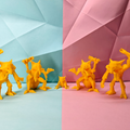 Yellow toy figures on a split background of light blue and pink with geometric patterns.