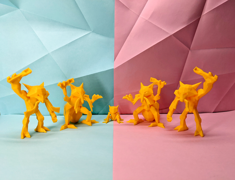Yellow toy figures on a split background of light blue and pink with geometric patterns.