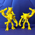 Three yellow printed figures on a blue textured background loking like a family of alakazam happy together