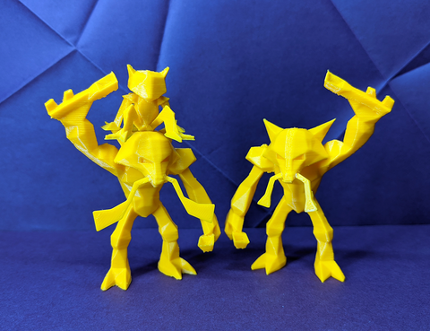 Three yellow printed figures on a blue textured background loking like a family of alakazam happy together