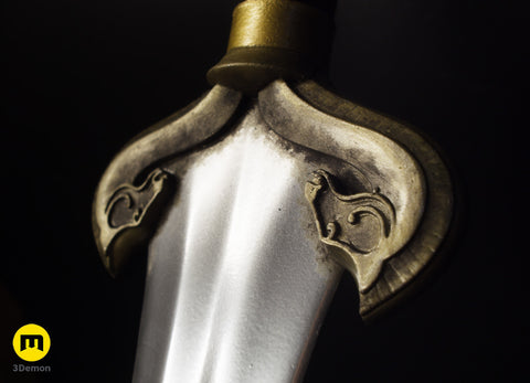 Close-up of a decorative eowyn sword hilt with intricate horse designs on a black background