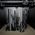Photo of Eowyn LOTR sword guard and handle parts in tan brown filament on heated bed of Original Prusa 3D printer