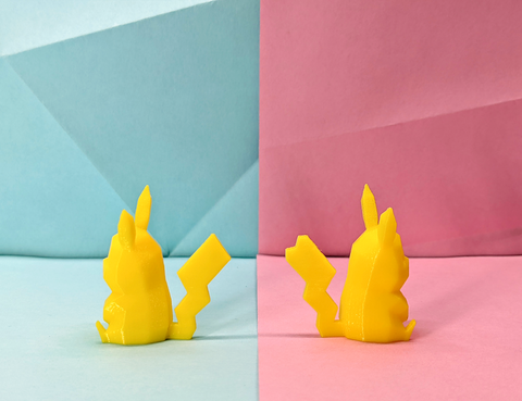 Yellow 3D printed Pikachu figurines on a pastel pink and blue geometric background. One is a girl, one is a boy.