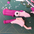 Disassembled parts of hero shooter game winged medic Blaster, pink and purple 3D printed cosplay prop pieces