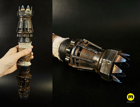 Hand photo of Rey Skywalker’s Lightsaber 3D print, black hilt with five-pronged guard, gold blade.