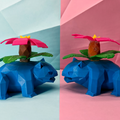 Two vunsaur facing each other on split  blue and pink background