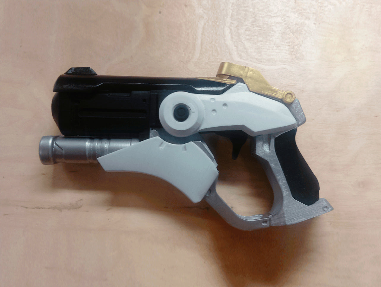 Digital 3D render of Overwatch Mercy Blaster STL, grey and black 3D printed cosplay prop.