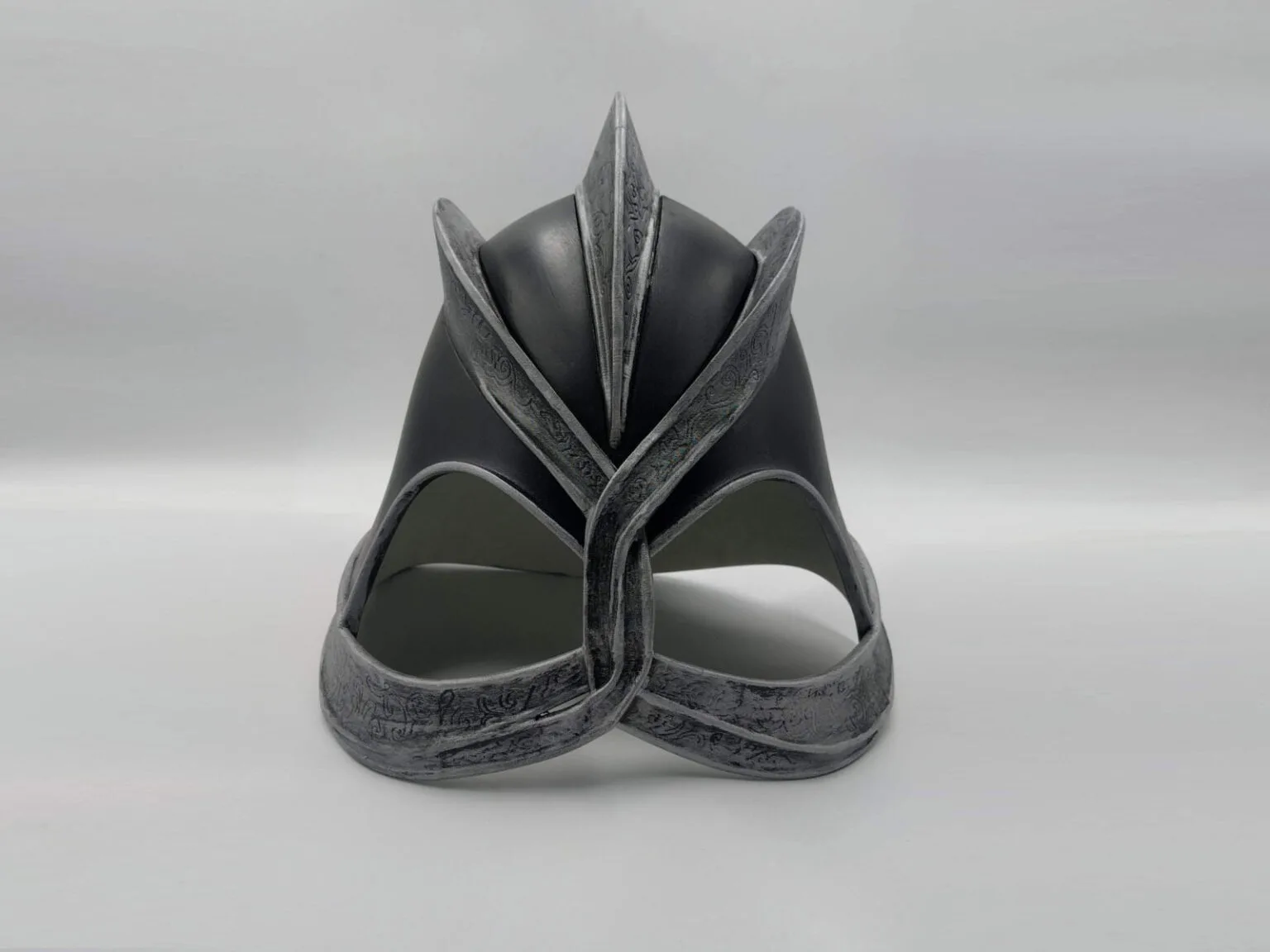 Real photo of a completed 3D printed and painted Dark Mountain Game of Thrones helmet placed on a surface.