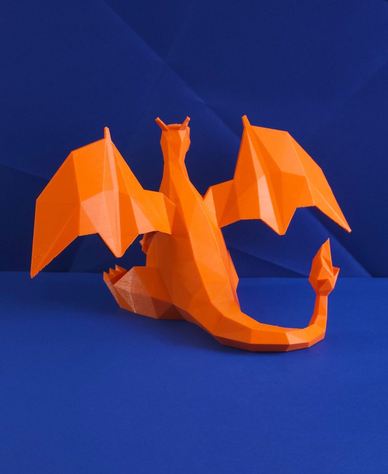 Side view photo of 3D printed Charizard STL collectible figure, orange, dynamic pose