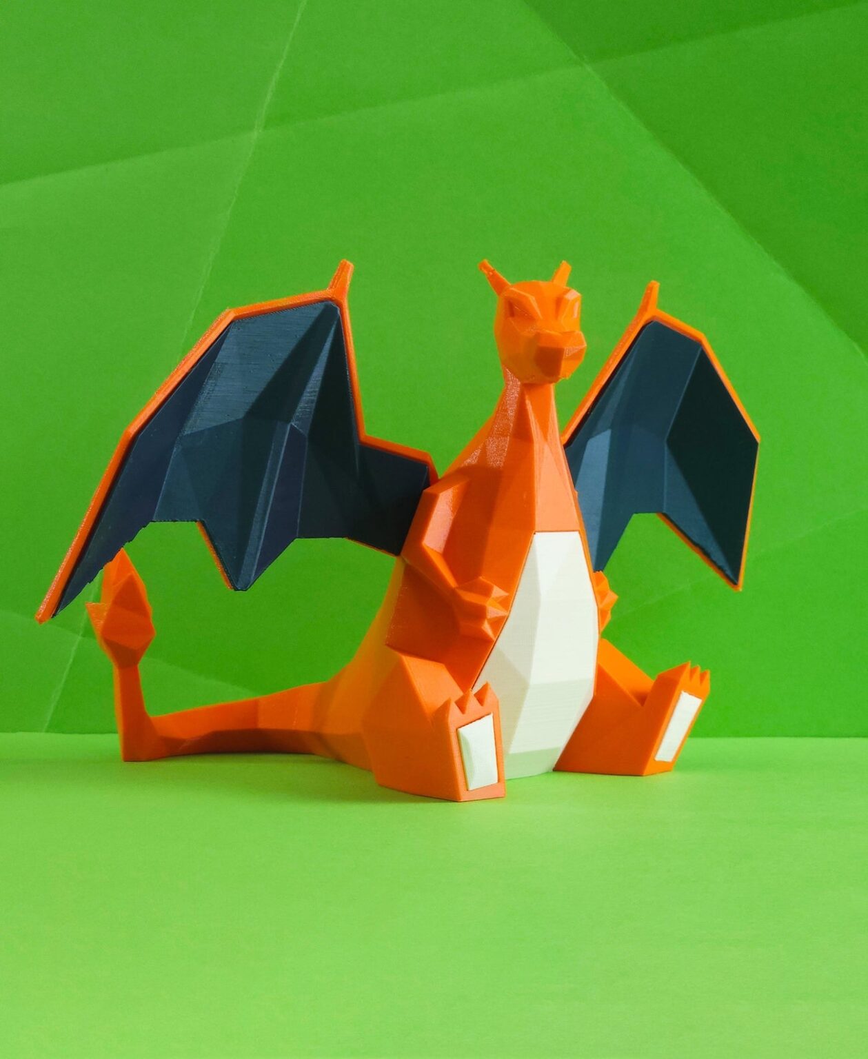 Photo of 3D printed Charizard STL collectible figure, orange/black wings, crouching front view