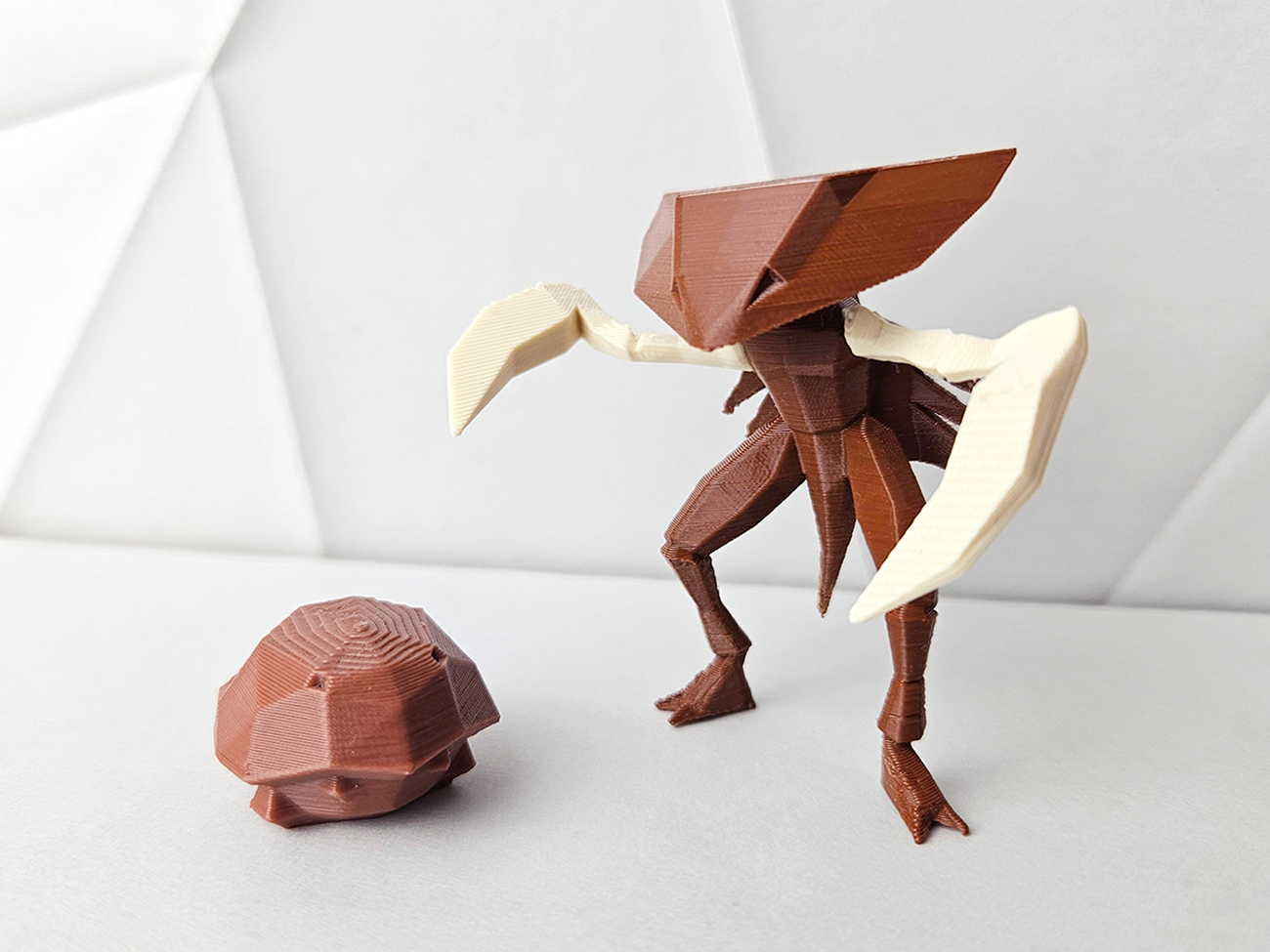 Photo of 3D printed Kabutops STL collectible figure, brown/white, dynamic pose, plain background