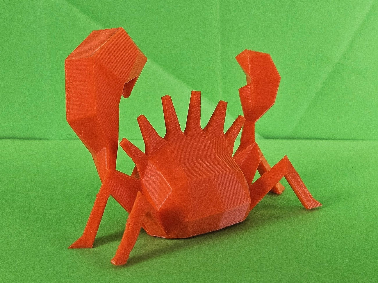 Kingler STL 3D printed collectible figure, red, side profile, plain green background