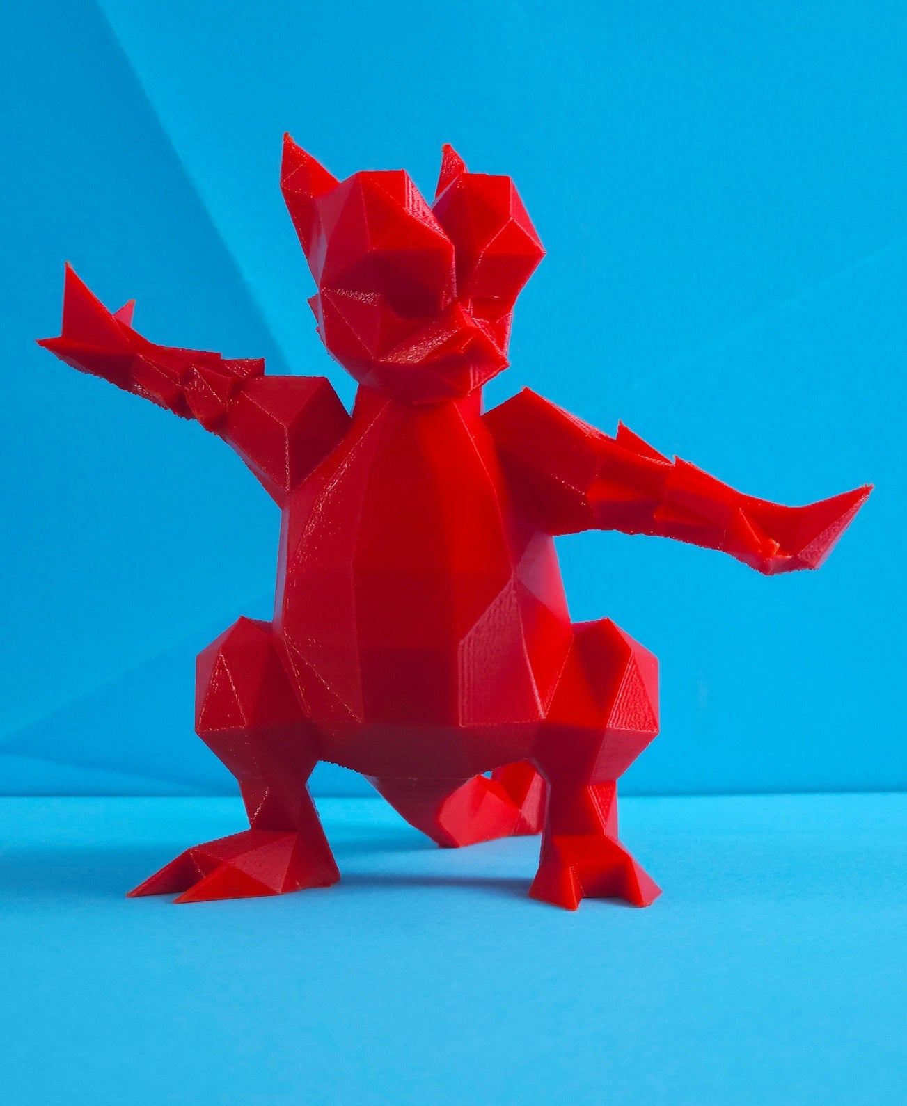 Magmar 3D printed collectible figure, red fiery pose, front view, plain background