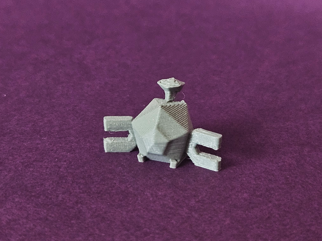 Photo of 3D printed Magnemite STL collectible figure, grey metallic texture, front view