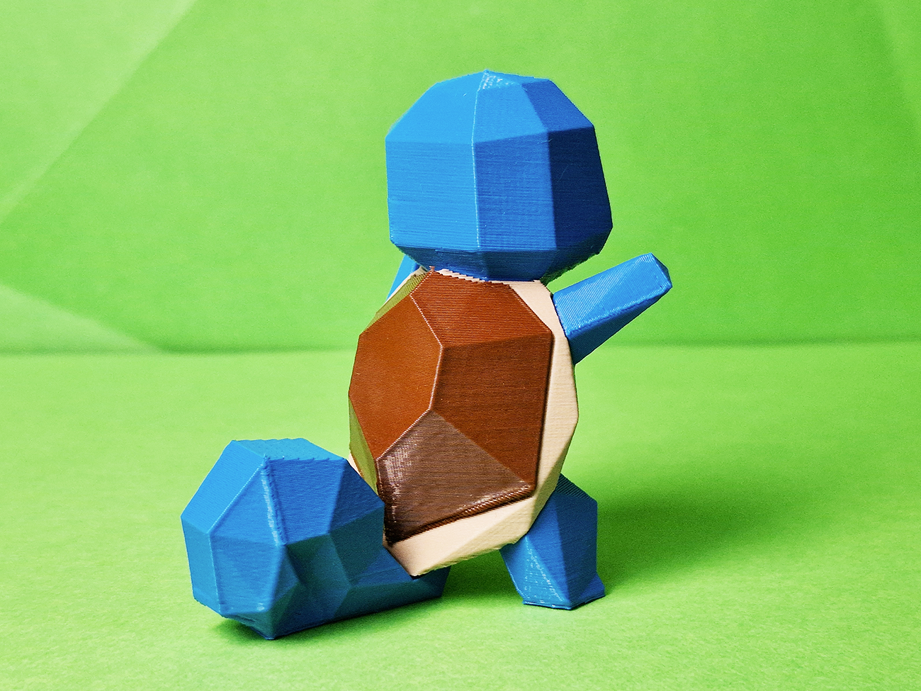 3D printed Squirtle STL collectible figure, blue shell, front view, green background
