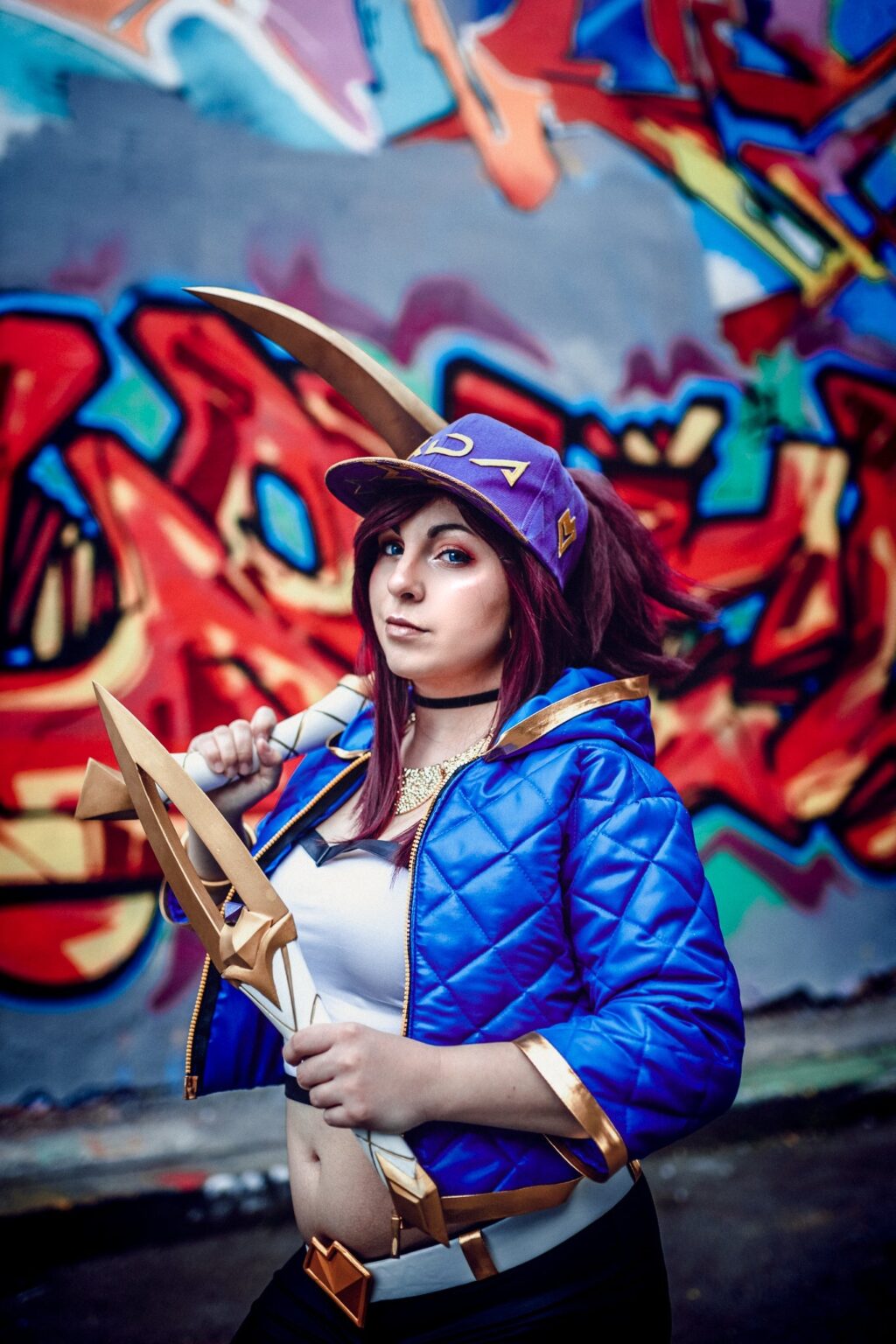 Lifestyle photo of KDA Akali’s Weapons - League of Legends, cosplay prop with bow and horn.