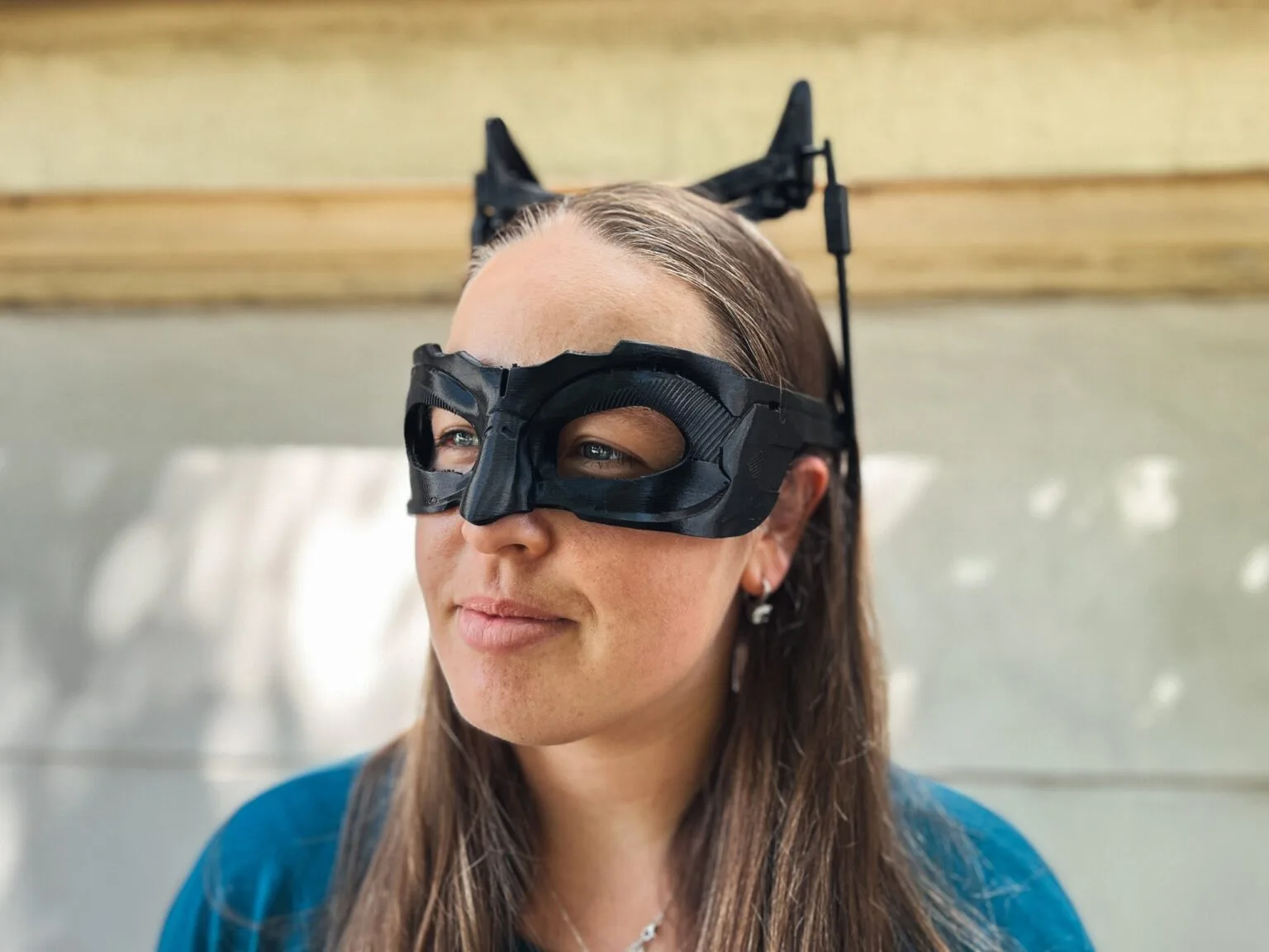 Lifestyle photo of Catwoman mask - Dark Knight Rises, black 3D printed cosplay prop with ear horns.