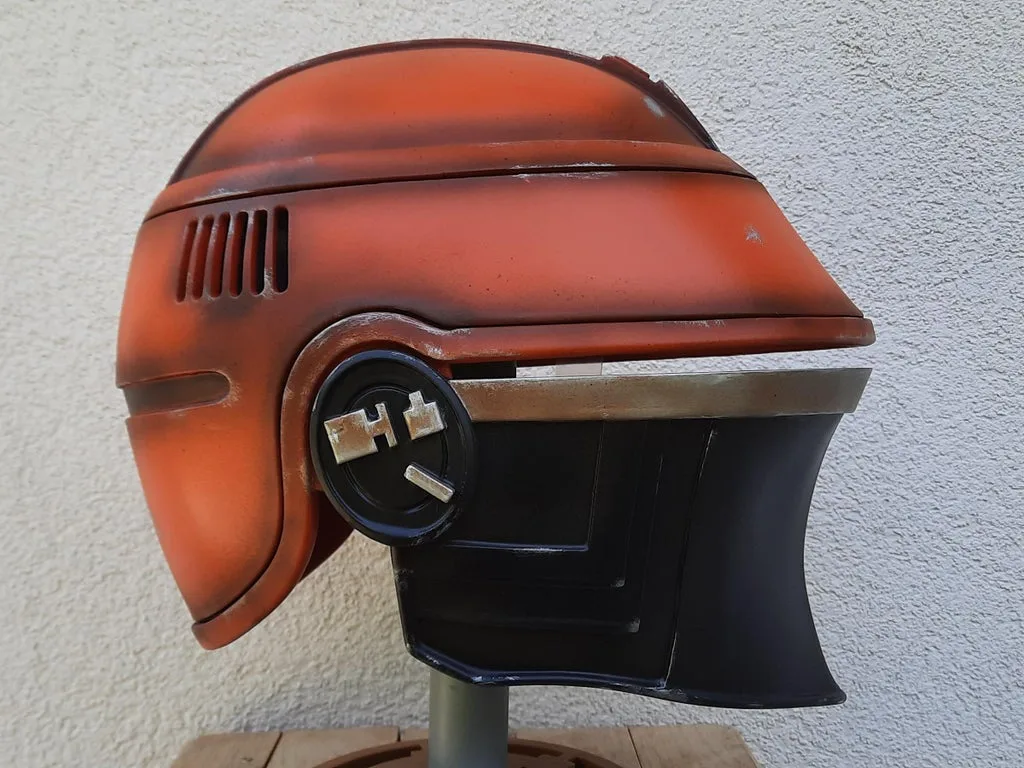 Painted 3D render of Fennec Shand helmet, orange-brown cosplay prop, side view detail