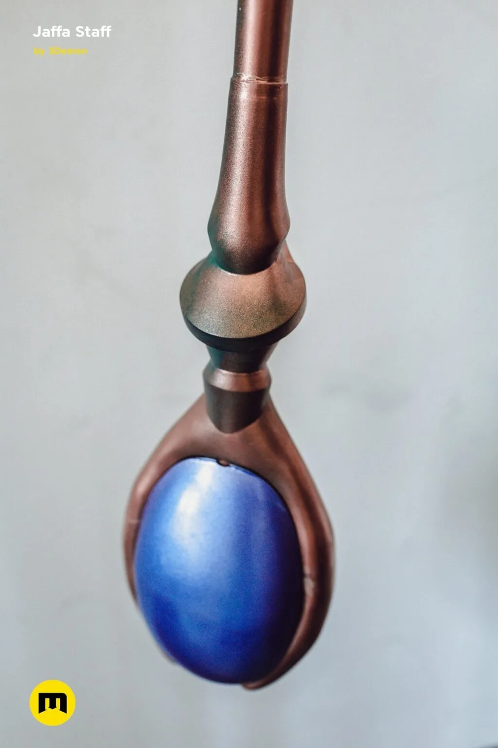 3D visualization of Ma'Tok Jaffa Staff, copper-toned handle with blue orb tip, fantasy lamp