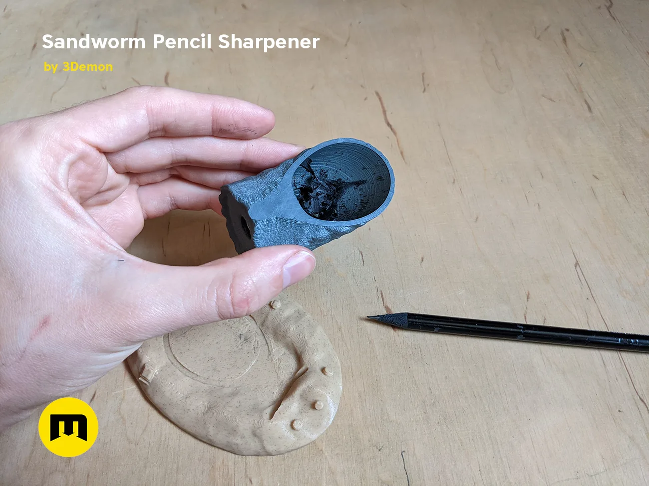 Hand photo of Sandworm Pencil Sharpener 3D print, Dune-inspired design held with pencil inside.