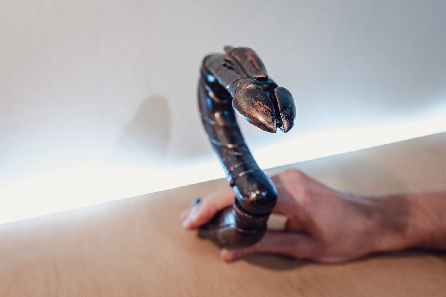Hand photo of Zat'nik'tel Gun STL, metallic finish pistol held in hand, 3D printed weapon