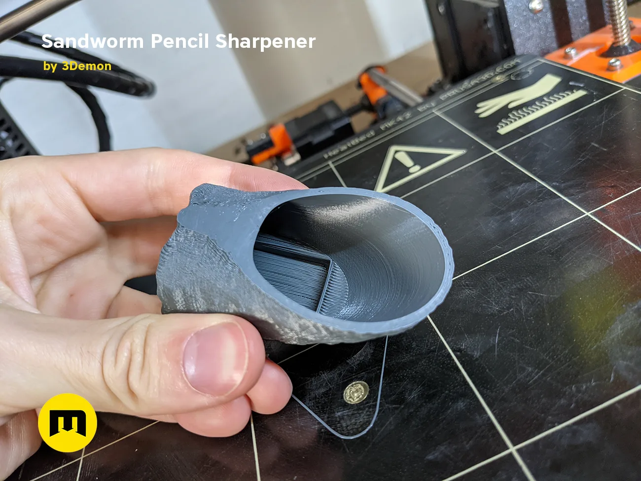 Hand photo of Sandworm Pencil Sharpener - Dune, grey 3D printed pencil holder with sand texture, 3D print