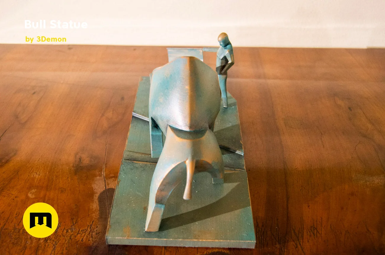 Lifestyle photo of 3D printed Bull Statue - Dune collectible figure, matte bronze finish on wooden surface
