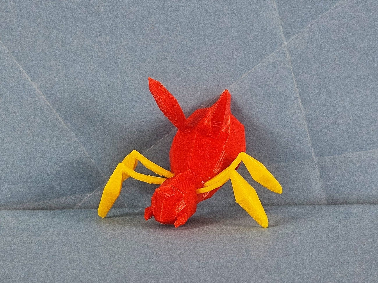 Color-coded parts breakdown of Ariados STL, red body and yellow legs, 3D print assembly guide