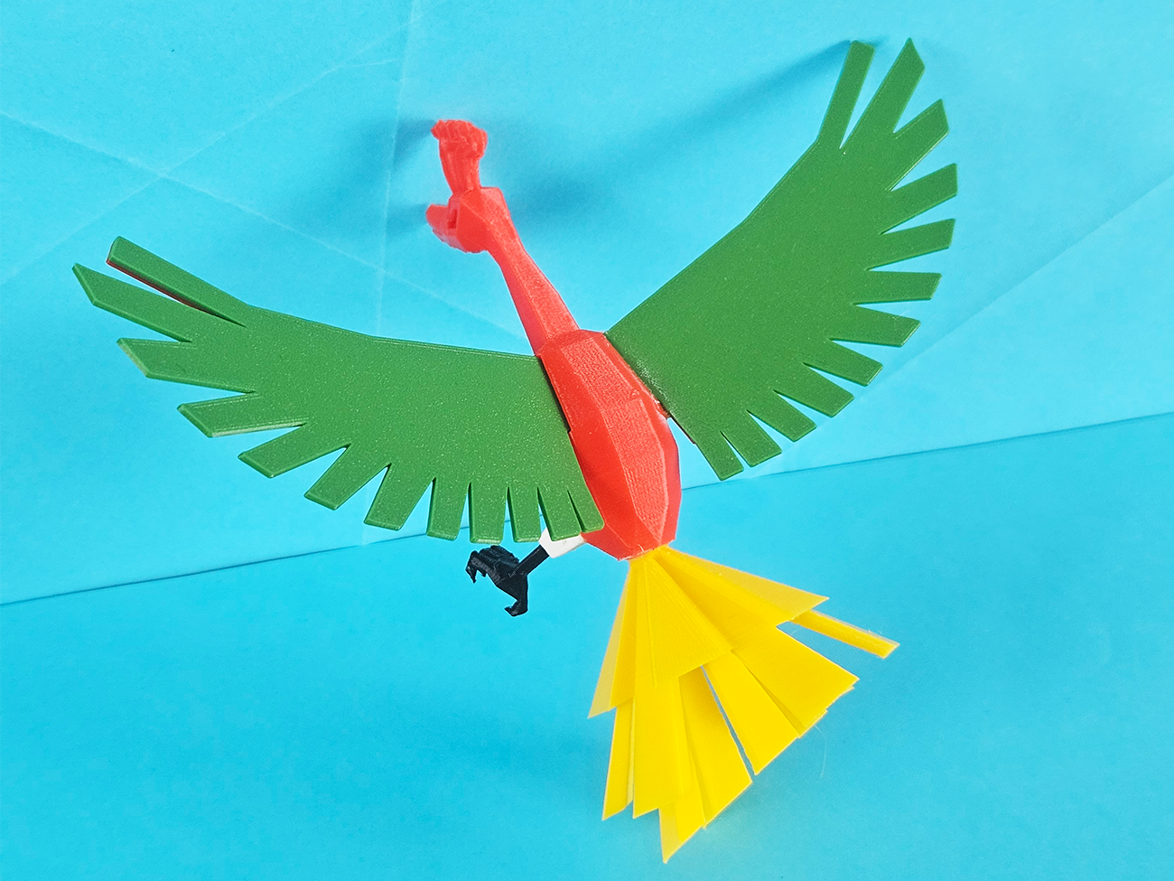 Color-coded parts breakdown of Ho-Oh 3D print, green wings, red body, yellow tail, collectible figure