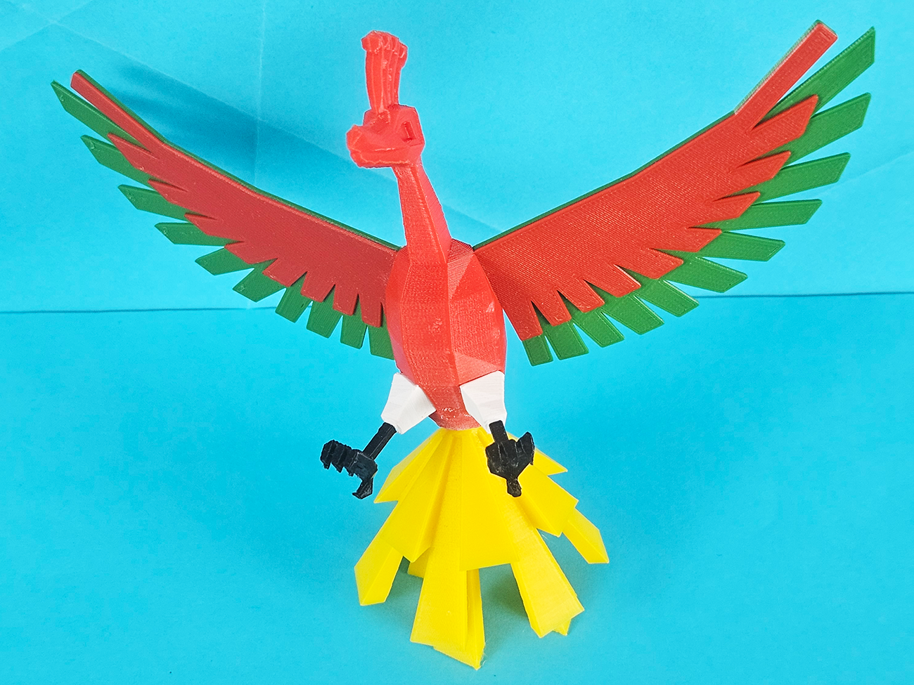 Color-coded parts breakdown of Ho-Oh 3D print, red wings, yellow tail, Pokémon collectible figure