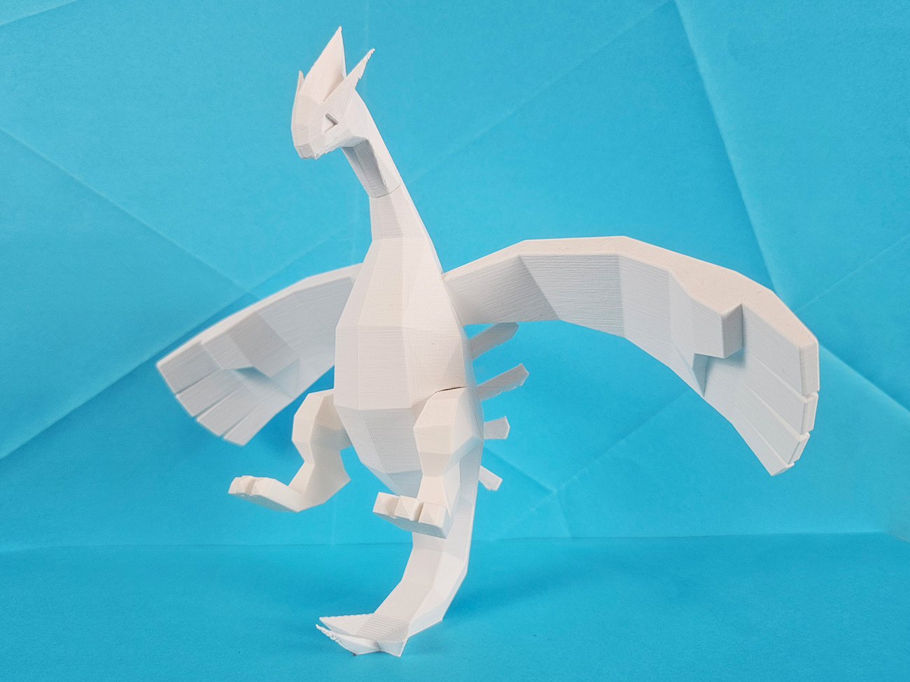 3D model render of Lugia, mythical Pokémon collectible figure, side profile view