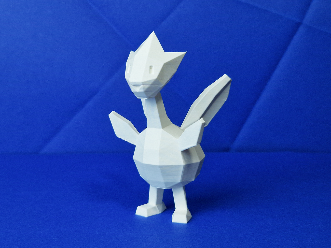 Wireframe mesh render of Togetic STL, side polygon structure with wing and tail detail, Pokémon collectible figure