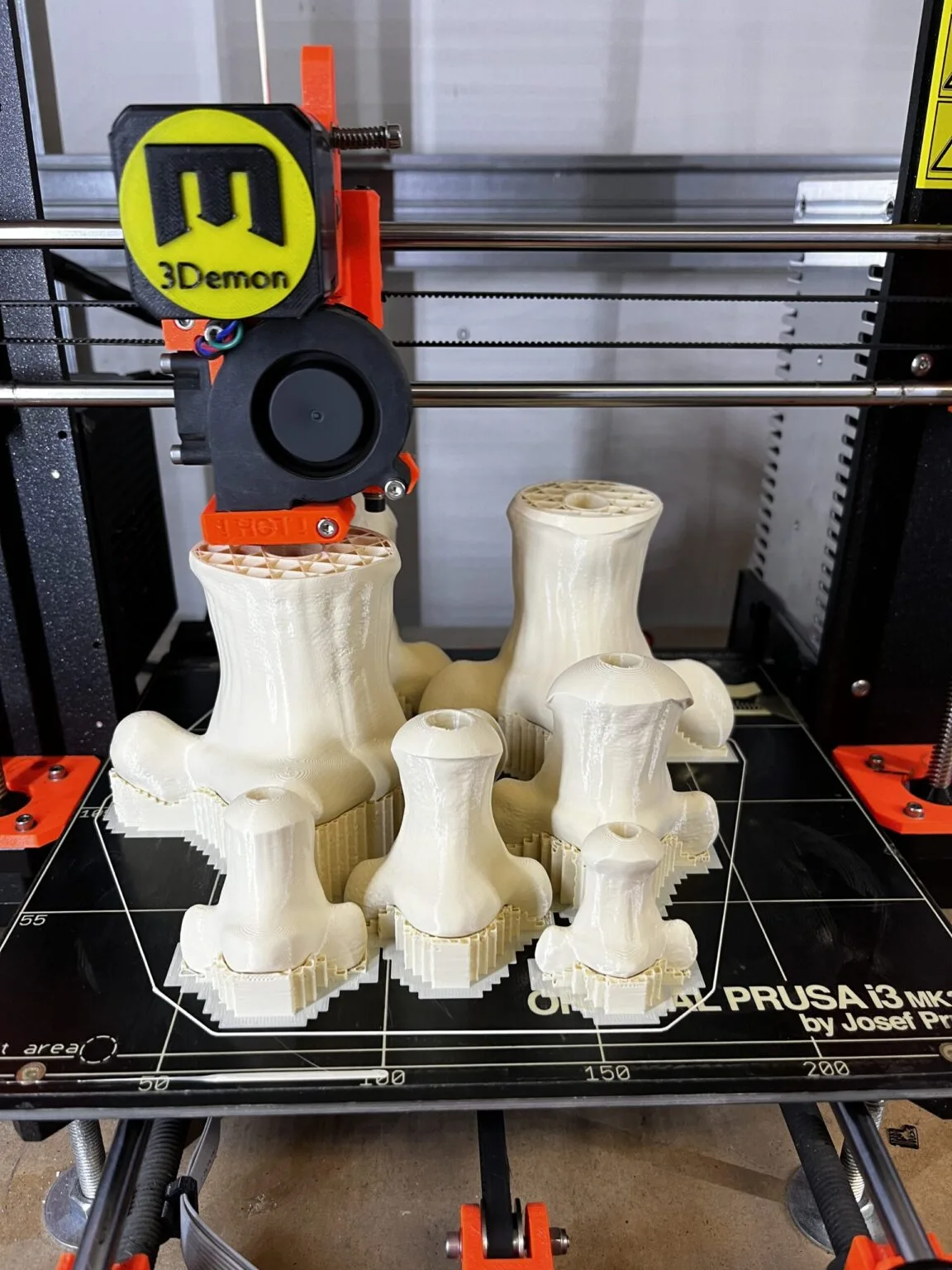 Disassembled parts of The Sandman’s helm STL, 3D printed white plastic, five segmented pieces.