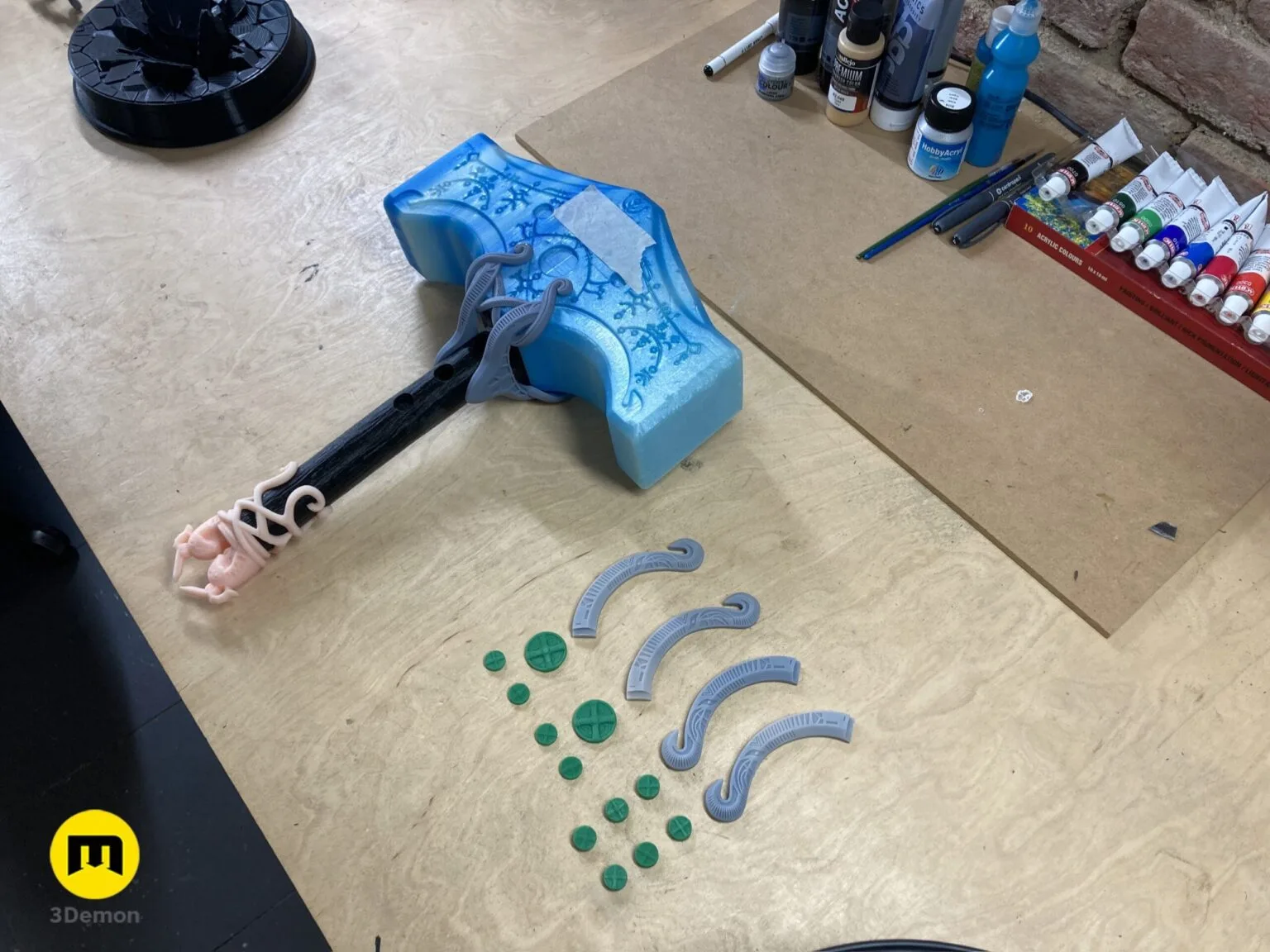 Disassembled parts of Mjolnir - God of War Ragnarok 3D print, blue handle, 6 green prongs, 3 straps.