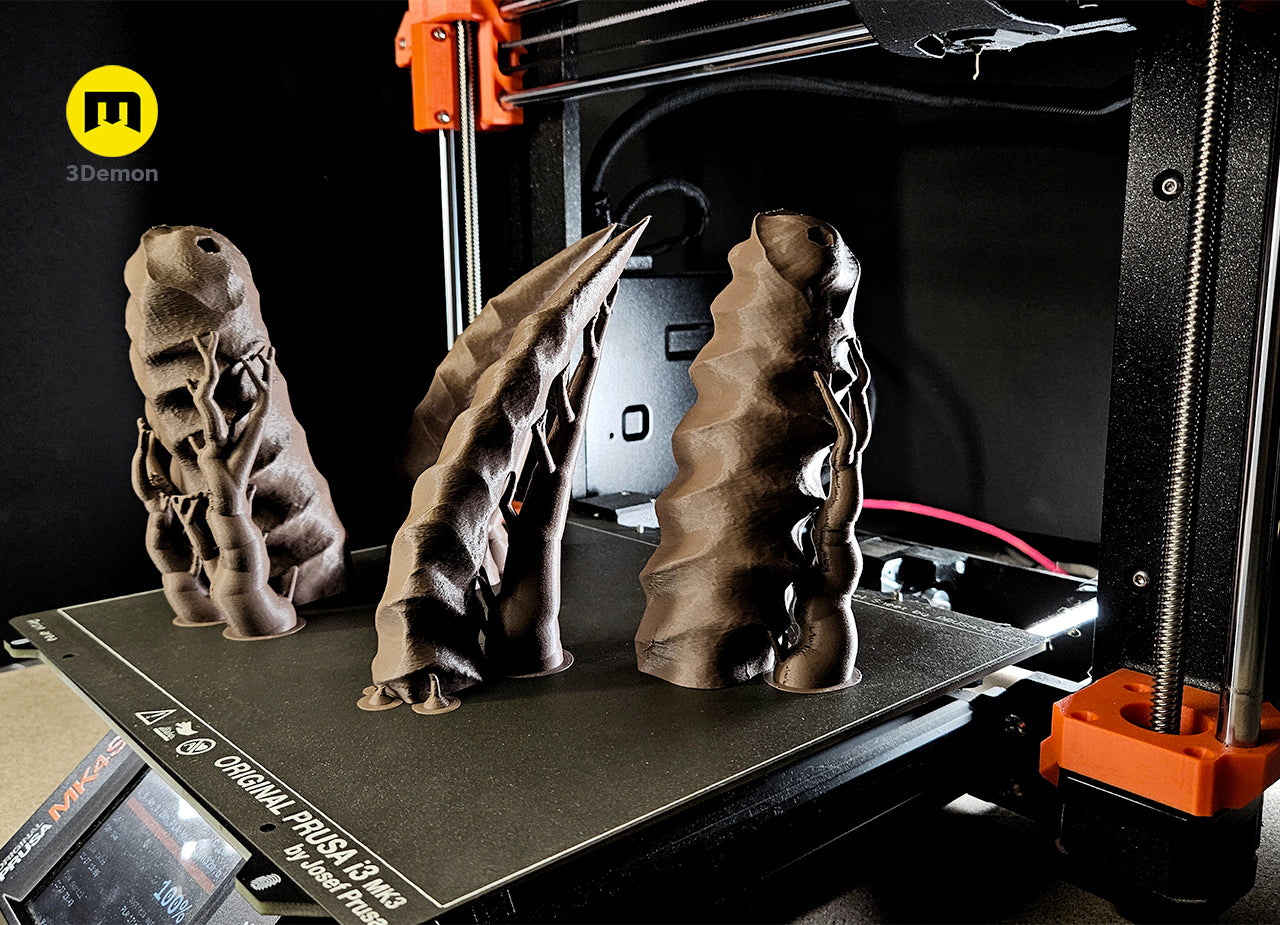 Disassembled parts of 3D printed Shaman Skull with Horns STL, two brown horned skull pieces.