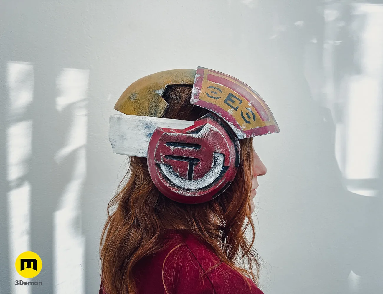 Lifestyle photo of 3D printed Sabine Speeder Helmet - Ahsoka cosplay prop, red and gold metallic.